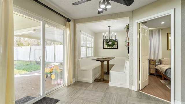 doorway featuring light hardwood / wood-style floors, a textured ceiling, breakfast area, and a chandelier