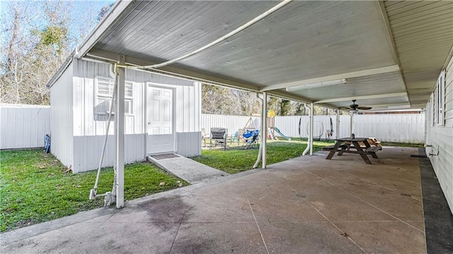 view of patio with a playground, an outdoor structure, and ceiling fan