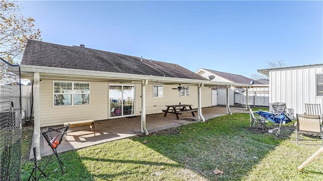 rear view of house with a lawn and a patio