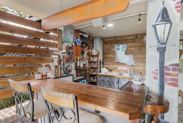 bar with sink and wooden walls