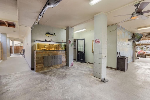 basement featuring ceiling fan and a fireplace