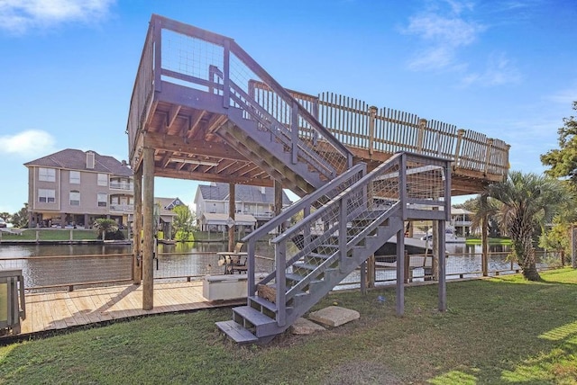 exterior space featuring a lawn and a water view