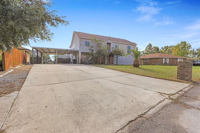 view of front facade with a carport and a front yard