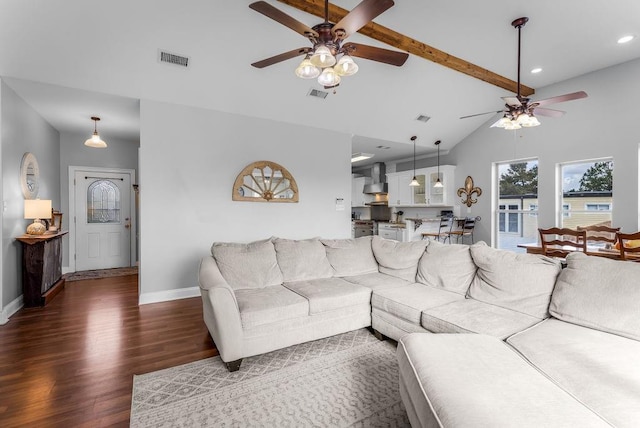 living room featuring dark wood-type flooring, ceiling fan, and vaulted ceiling with beams