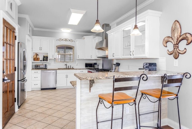 kitchen featuring white cabinetry, a breakfast bar, appliances with stainless steel finishes, and kitchen peninsula