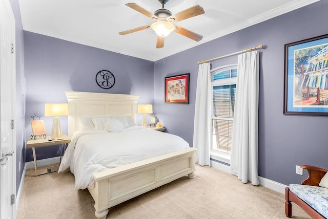 bedroom with ceiling fan, ornamental molding, and light carpet