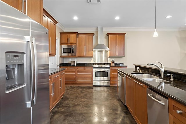 kitchen featuring crown molding, hanging light fixtures, appliances with stainless steel finishes, sink, and wall chimney range hood