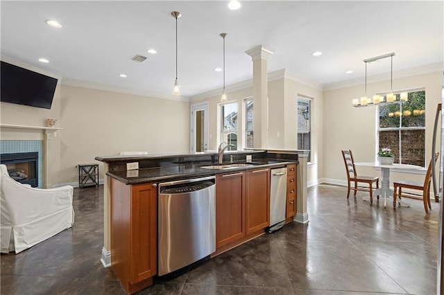 kitchen with pendant lighting, a fireplace, stainless steel dishwasher, a center island with sink, and crown molding