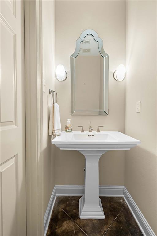 1207 Rue Degas, Mandeville, LA 70471 - bathroom featuring tile patterned floors and baseboards