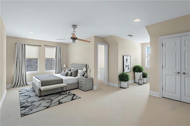 1207 Rue Degas, Mandeville, LA 70471 - bedroom featuring light colored carpet, recessed lighting, multiple windows, ceiling fan, and a closet
