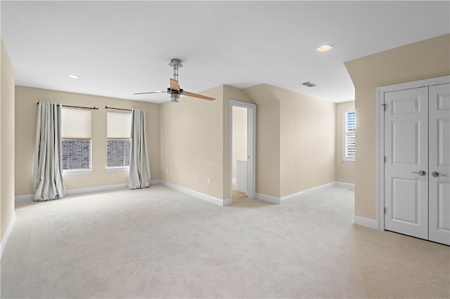 carpeted empty room featuring ceiling fan