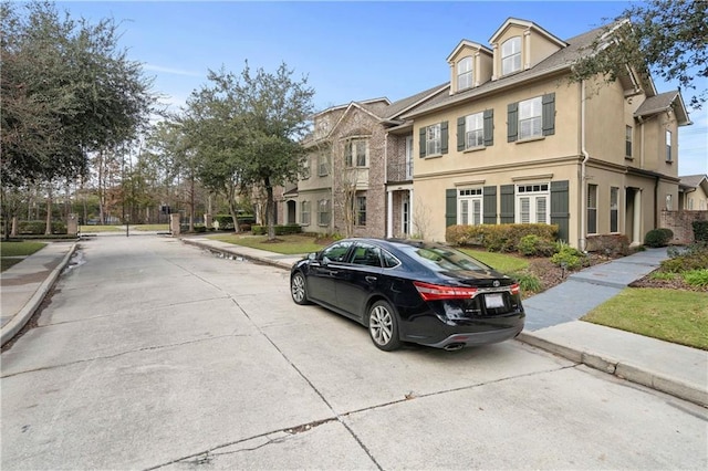 1207 Rue Degas, Mandeville, LA 70471 - view of front facade with stucco siding