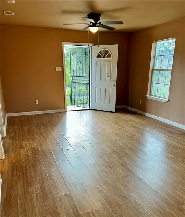 empty room featuring light hardwood / wood-style flooring and ceiling fan