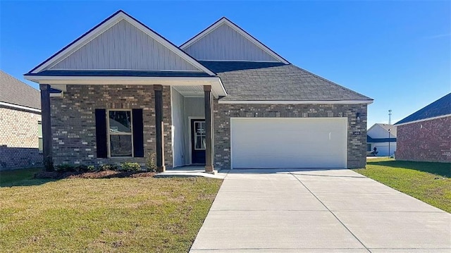 craftsman-style home featuring board and batten siding, brick siding, driveway, a front lawn, and an attached garage