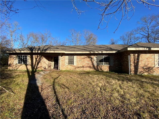 rear view of house with a yard