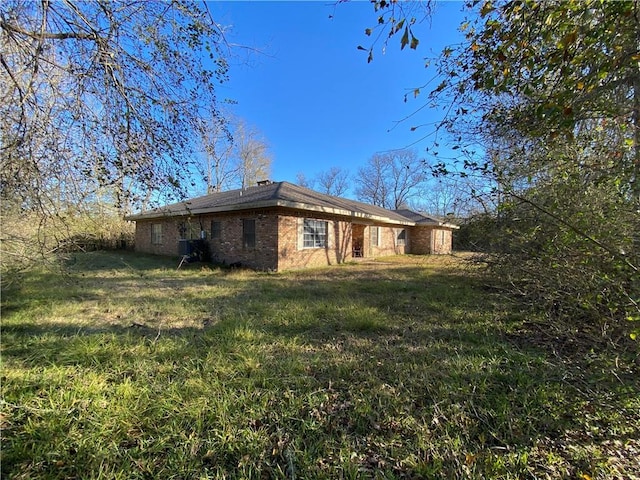 view of side of home featuring a yard