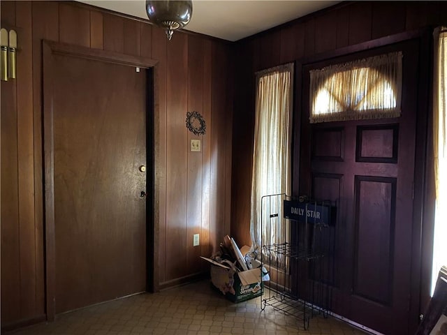 foyer with wooden walls