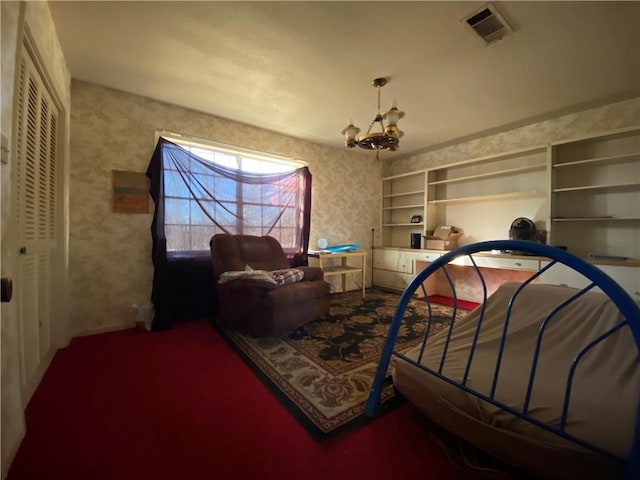 bedroom featuring an inviting chandelier and a closet