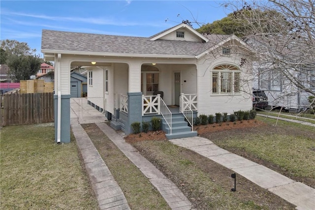 bungalow-style home with a front yard and a porch