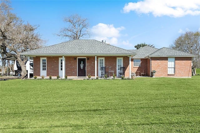 view of front of home with a front yard and brick siding