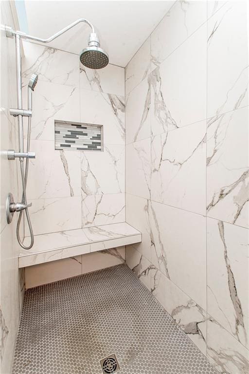 bathroom with tiled shower