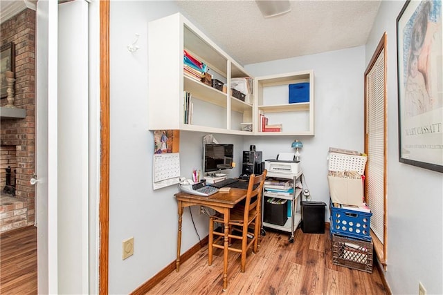 office space with light hardwood / wood-style floors and a textured ceiling