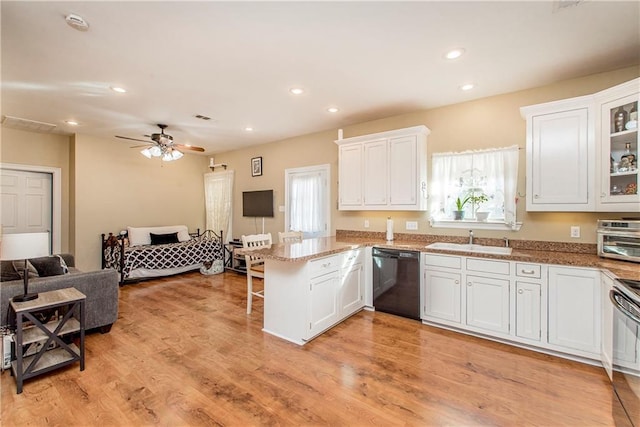 kitchen featuring kitchen peninsula, sink, white cabinetry, and black dishwasher