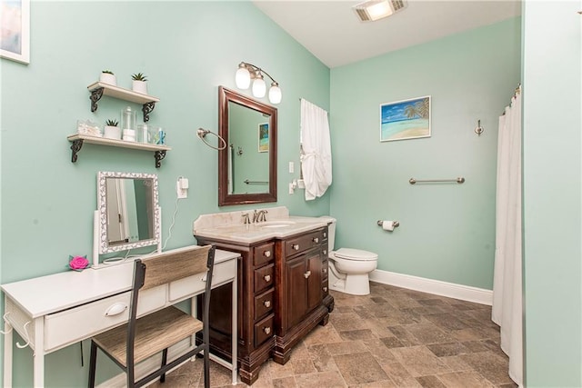 bathroom featuring toilet and vanity