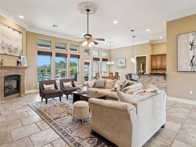 living room with crown molding and ceiling fan