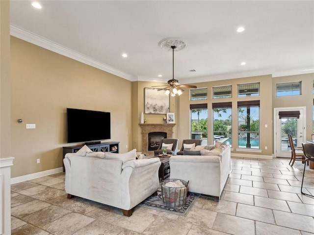 living room featuring ceiling fan and ornamental molding