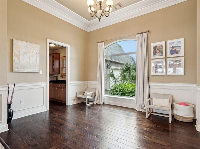 entryway with an inviting chandelier, dark hardwood / wood-style flooring, and crown molding