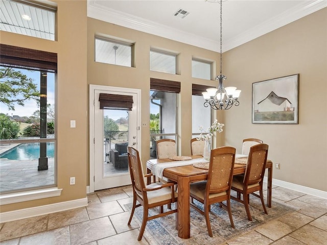 dining area with a chandelier and crown molding