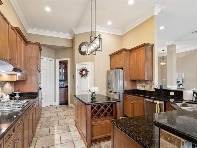 kitchen featuring tasteful backsplash, pendant lighting, dark stone counters, and appliances with stainless steel finishes