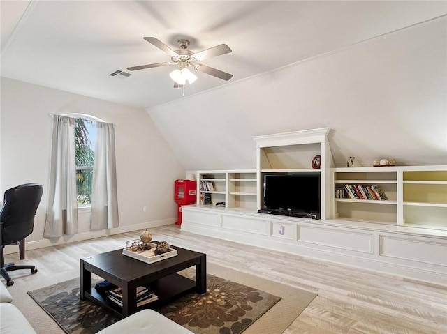 living room with hardwood / wood-style flooring, vaulted ceiling, and ceiling fan