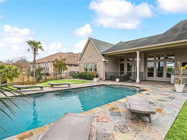 view of swimming pool featuring ceiling fan, french doors, and a patio