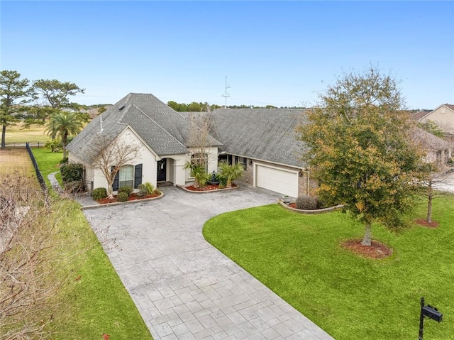 view of front of home featuring a garage and a front yard