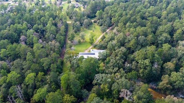 birds eye view of property featuring a view of trees