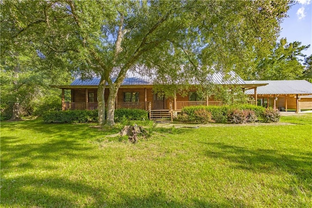 view of front of property featuring log veneer siding, a front yard, covered porch, and metal roof