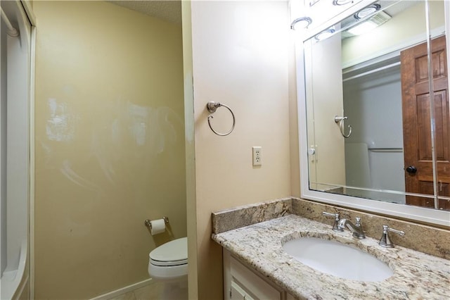 bathroom featuring toilet and vanity