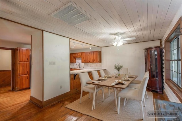 dining room featuring hardwood / wood-style floors, baseboards, visible vents, ceiling fan, and wooden ceiling