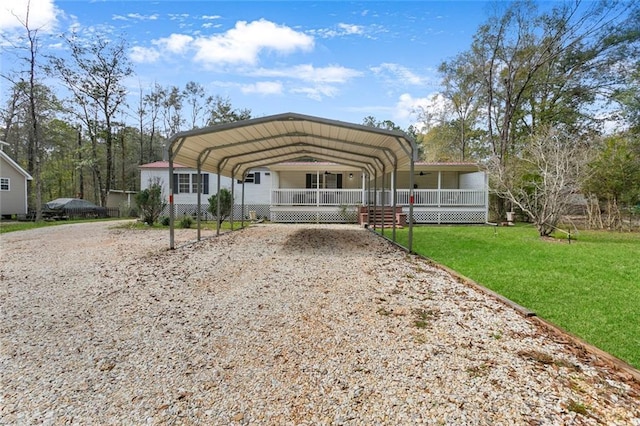 view of front of house with a carport, covered porch, and a front yard