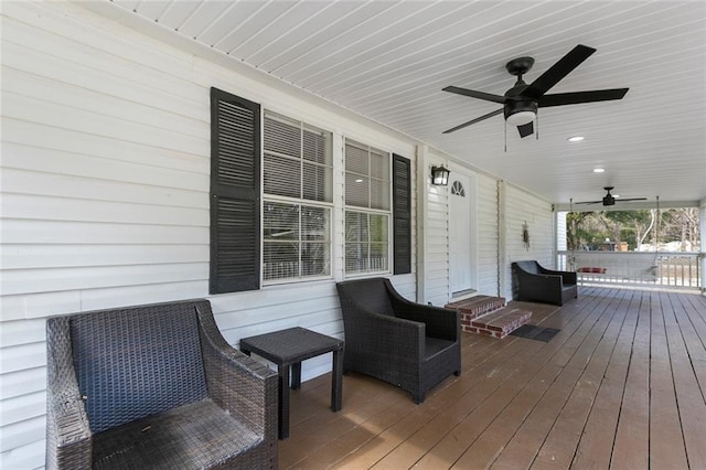 wooden terrace with ceiling fan and covered porch