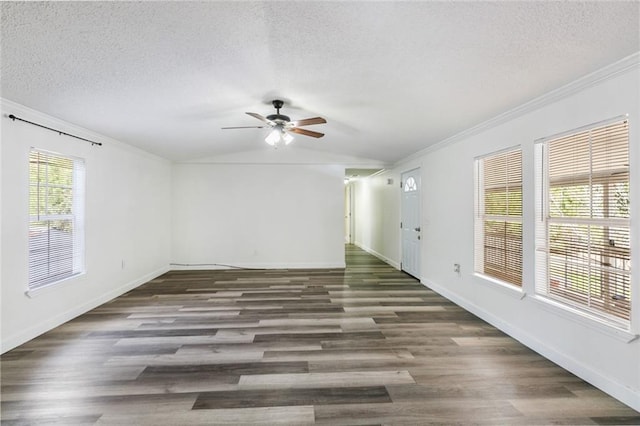 spare room featuring vaulted ceiling, ornamental molding, a textured ceiling, and dark hardwood / wood-style flooring