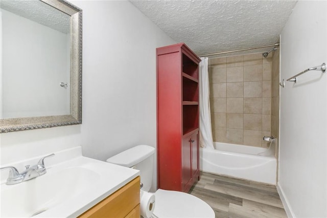 full bathroom with shower / bathtub combination with curtain, hardwood / wood-style flooring, vanity, a textured ceiling, and toilet