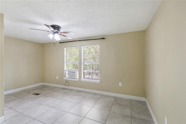 unfurnished room featuring light tile patterned flooring, ceiling fan, a textured ceiling, and cooling unit