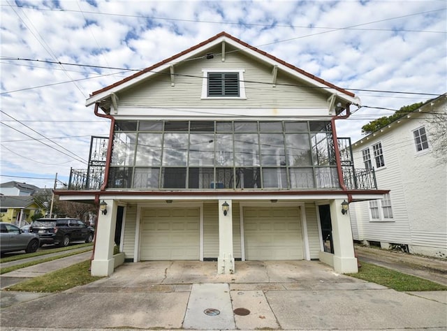 4937-39 S Miro St, New Orleans, LA 70125 - view of front of home featuring a sunroom, driveway, and a garage