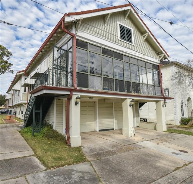 view of home's exterior featuring a garage and a sunroom