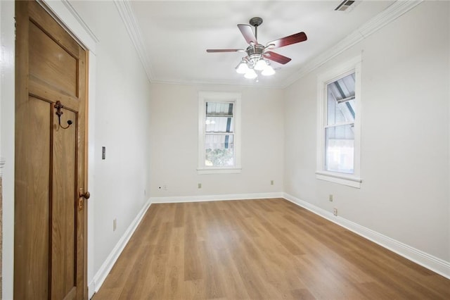 empty room with ceiling fan, light hardwood / wood-style flooring, and ornamental molding