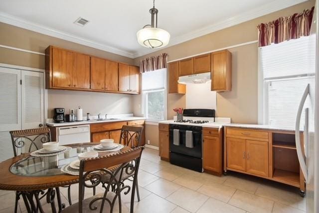 kitchen featuring pendant lighting, sink, white appliances, and ornamental molding