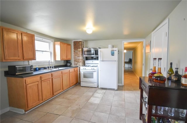 4937-39 S Miro St, New Orleans, LA 70125 - kitchen featuring dark countertops, a sink, light tile patterned flooring, white appliances, and brown cabinetry